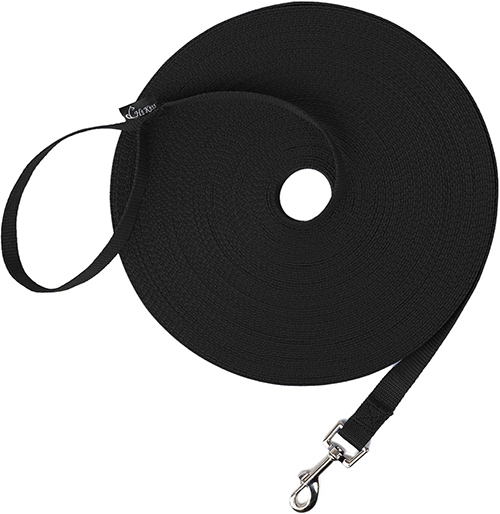 An extra long black dog and puppy training leash rolled in a circle